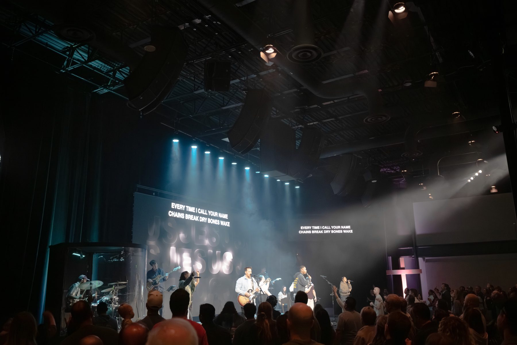 Colored wash lighting across a venue stage